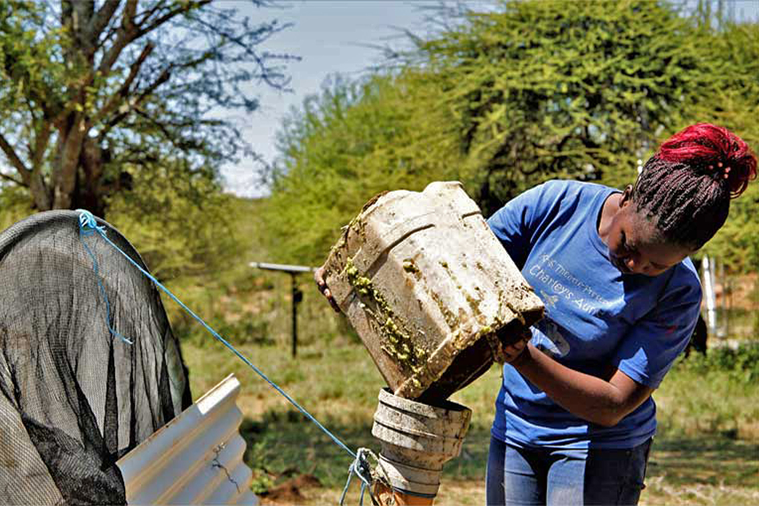 refilling biogas digester with prickly pear pulp. credit Anthony Langat.